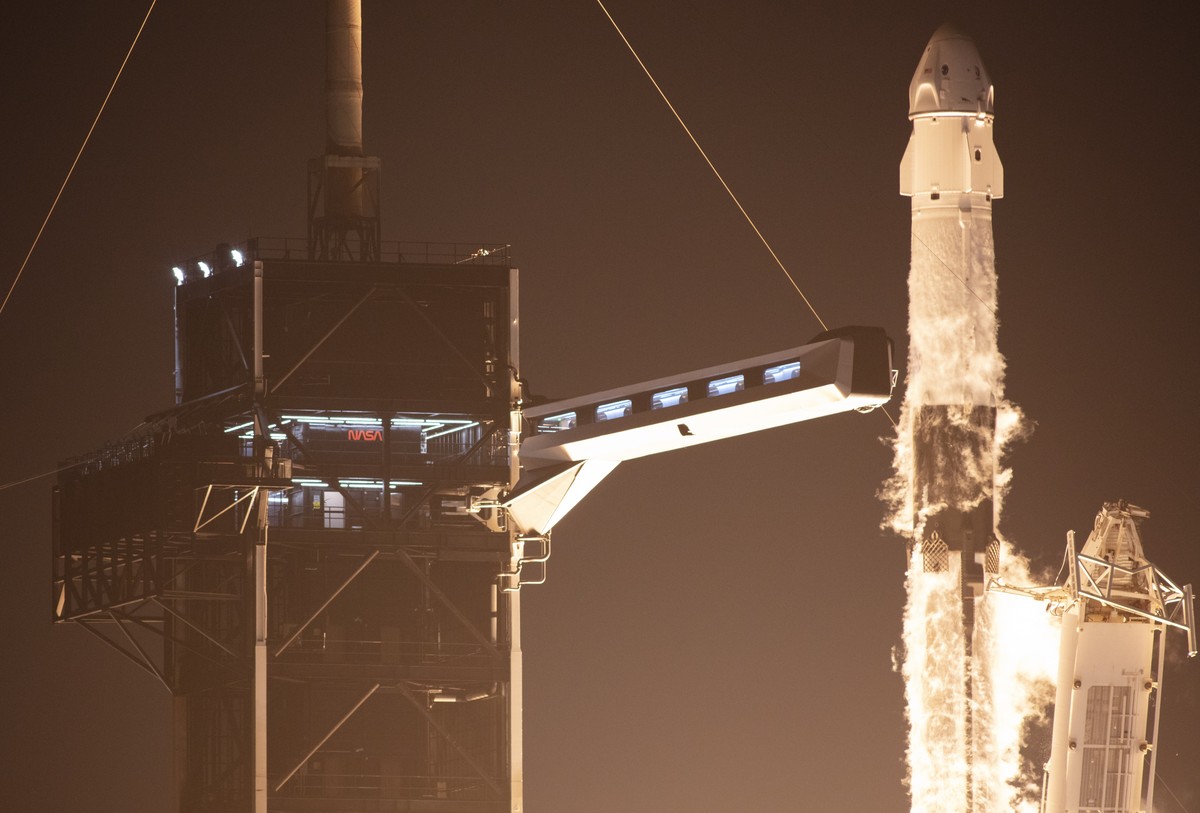 epa09911921 A handout picture made available by the National Aeronautics and Space Administration (NASA) shows a SpaceX Falcon 9 rocket carrying the company's Crew Dragon spacecraft being launche ...