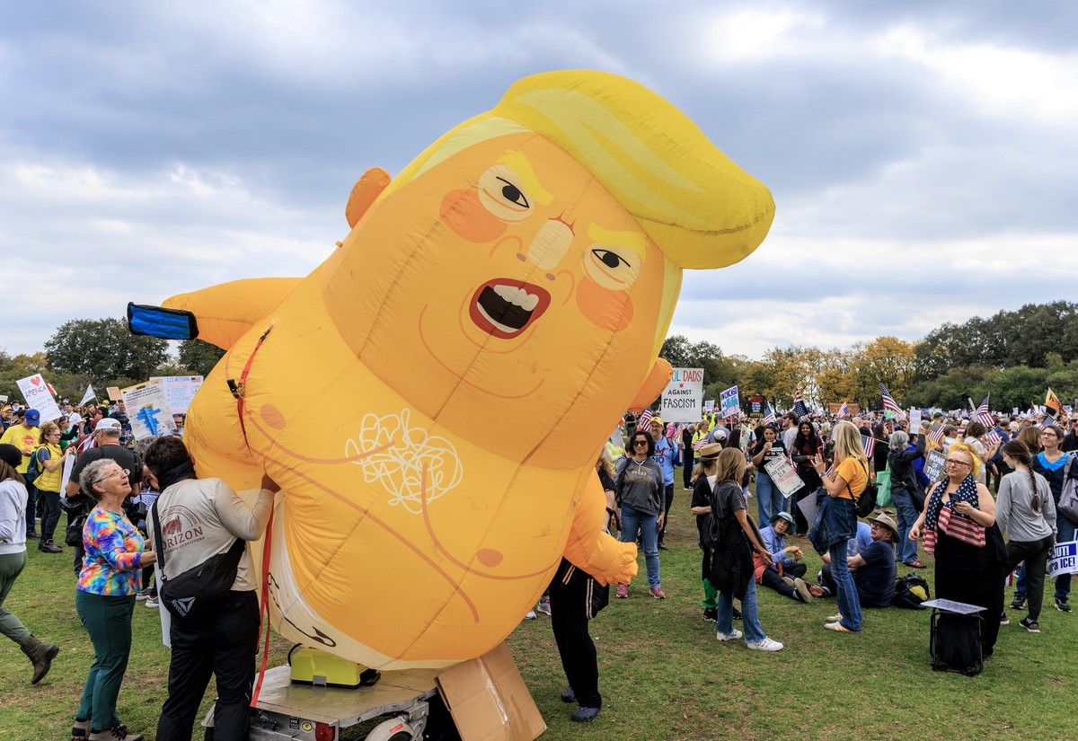 epa12462690 A Donald Trump baby balloon is displayed during the 'No Kings' protest in Downtown Chicago, Illinois, USA, 18 October 2025. The protest is part of a nationwide 'No Kings ...