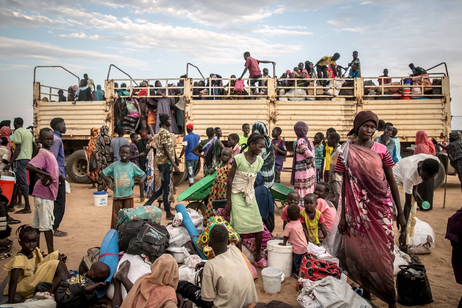 March 19, 2024, Renk, South Sudan: People fleeing the Sudanese war disembark a truck which has brought them to Renk from the Joda border crossing in South Sudan. Most will stay in the transit centre t ...