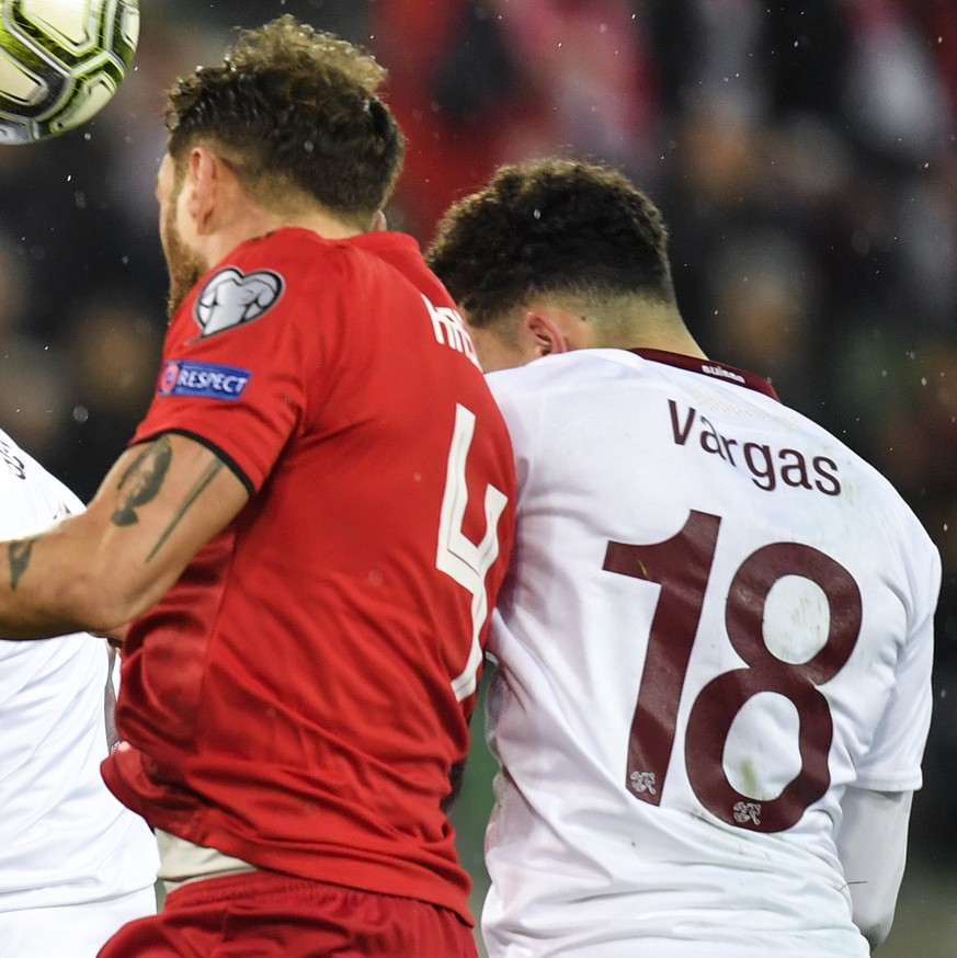 epa08000411 Switzerland's forward Albian Ajeti, left, and Switzerland's forward Ruben Vargas, fight for the ball with Georgia's Guram Kashia, center, during the UEFA Euro 2020 qualifyin ...