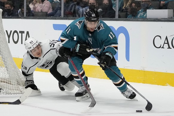 Los Angeles Kings defenseman Jordan Spence (53) battles for the puck against San Jose Sharks center Andrew Cogliano (11) during the third period of an NHL hockey preseason game Tuesday, Sept. 28, 2021 ...