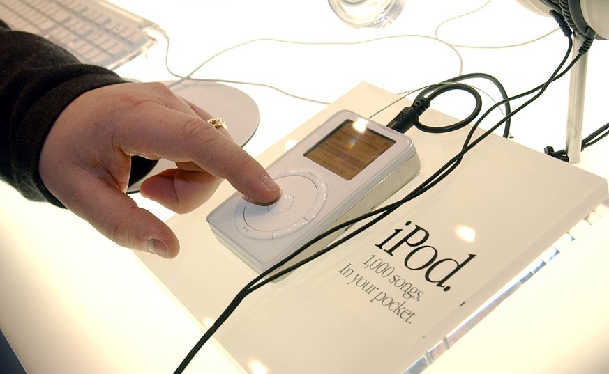 399358 06: A man touches the Apple iPod mp3 music player on display during the Macworld Conference and Convention January 8, 2002 at the Moscone Center in San Francisco. The conference officially open ...