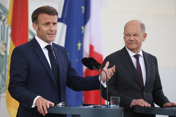 epa11375932 French President Emmanuel Macron (L) gestures next to German Chancellor Olaf Scholz during a joint press conference at Meseberg Palace in Meseberg near Gransee, Germany, 28 May 2024. Frenc ...