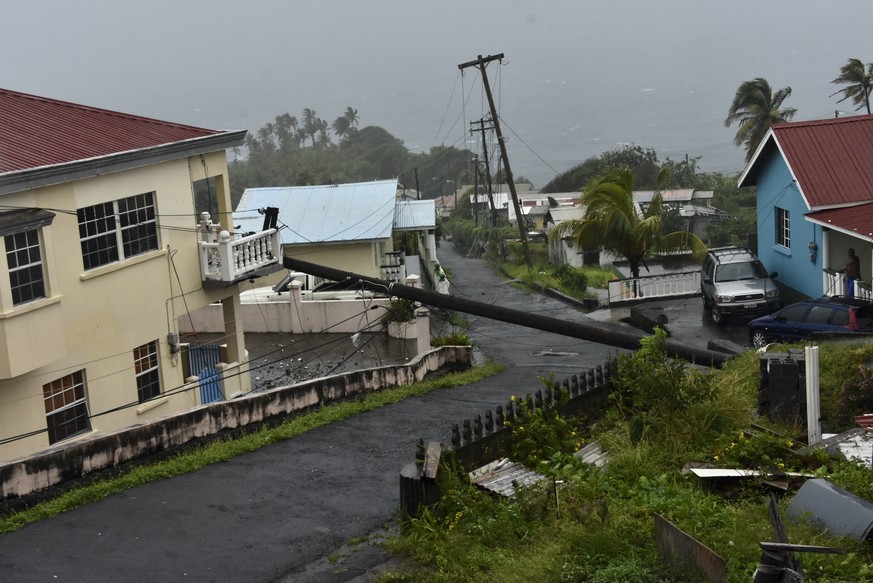 An electrical pole felled by Hurricane Elsa leans on the edge of a residential balcony, in Cedar Hills, St. Vincent, Friday, July 2, 2021. Elsa strengthened into the first hurricane of the Atlantic se ...