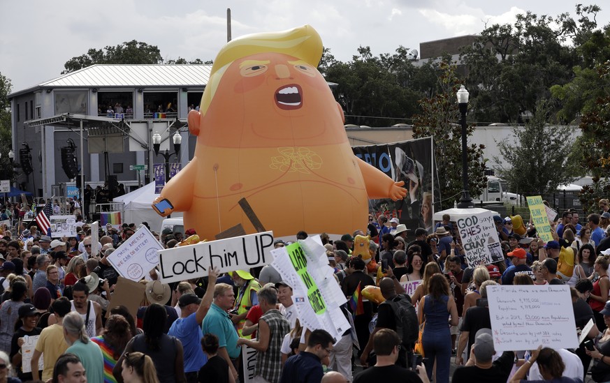 An inflatable Baby Trump balloon towers over protestors during a rally Tuesday, June 18, 2019, in Orlando, Fla. A large group was protesting against President Donald Trump was rallying near where Trum ...