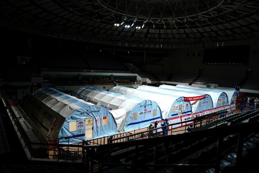 In this photo released by China&#039;s Xinhua News Agency, a temporary COVID-19 testing lab is seen in an arena in Shanghai, China, Friday, April 15, 2022. Anti-virus controls that have shut down some ...