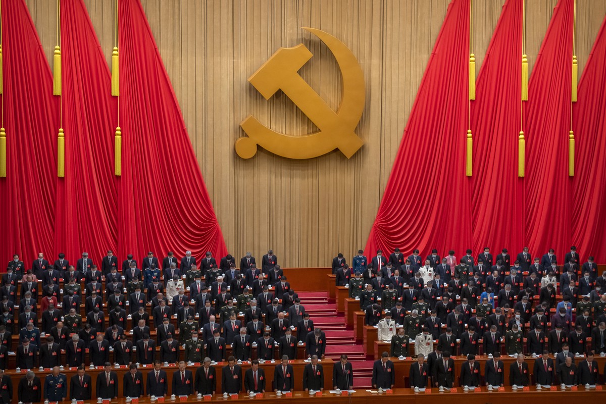 Delegates stand for a moment of silence during the opening ceremony of the 20th National Congress of China's ruling Communist Party at the Great Hall of the People in Beijing, China, Sunday, Oct. ...