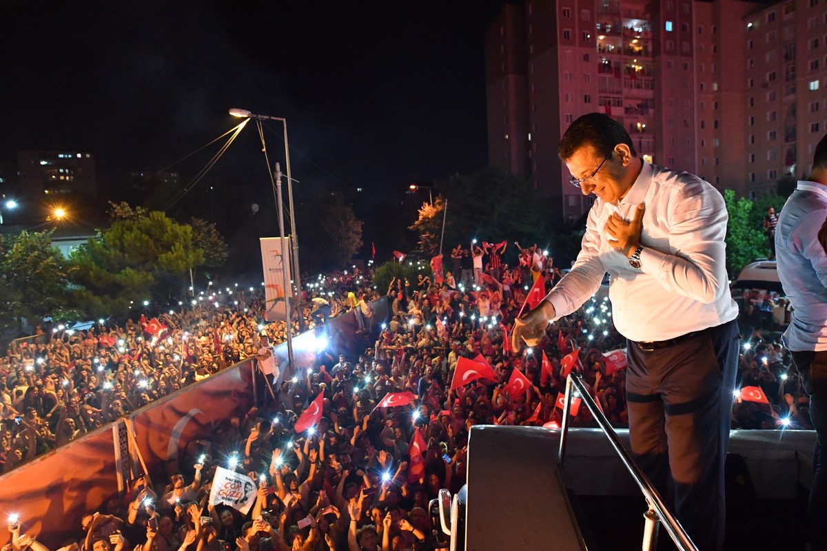 epa07669622 A handout photo made available by the CHP Press office shows newly elected Istanbul Mayor Ekrem Imamoglu of Republican People's Party (CHP) greets his supporters as they gather during ...