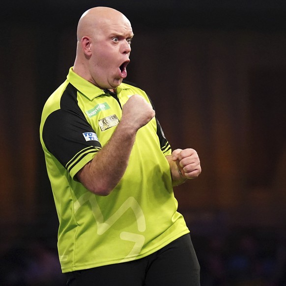 Netherland&#039;s Michael van Gerwen reacts during his match against England&#039;s Stephen Busting, right, on day twelve of the Paddy Power World Darts Championship at Alexandra Palace, London, Frida ...