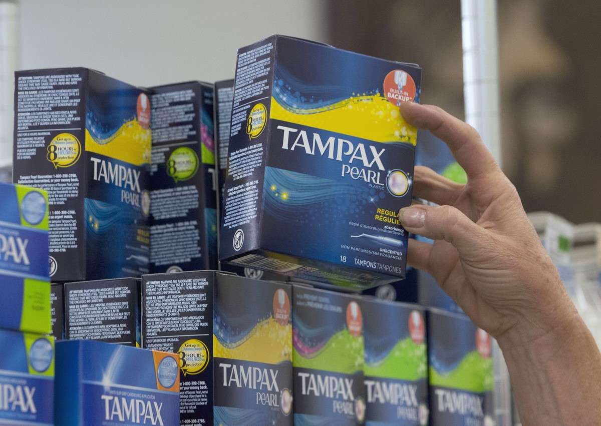FILE - In this June 22, 2016, file photo, Tammy Compton restocks tampons at Compton's Market, in Sacramento, Calif. California public schools and colleges would have to stock their restrooms with ...