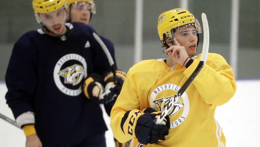 Nashville Predators left wing Kevin Fiala, right, of Switzerland, waits to run a drill during NHL hockey training camp Monday, Sept. 18, 2017, in Nashville, Tenn. Fiala arrived at camp healthy after s ...