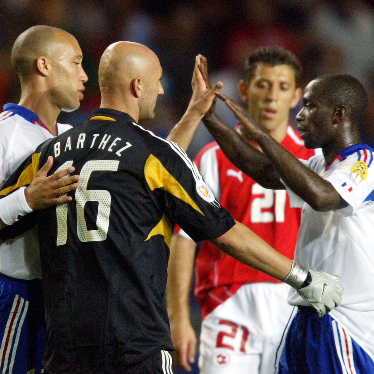 France's Mikael Silvestre, left, Fabien Barthez and Claude Makalele embrace after their 3-1 win over Switzerland in a Group B Euro 2004 first round match at the Cidade de Coimbra Stadium, in Coim ...