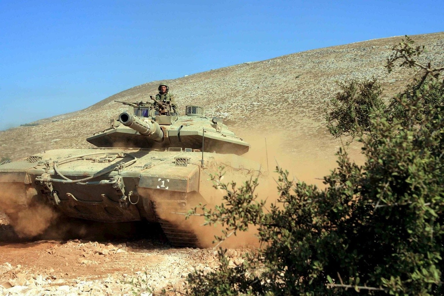 An Israeli tank at the Lebanese side of the border near the village of Maroun Al-Ras during an evacuation operation of injured soldiers as fierce battles were ongoing near the southern Lebanese town o ...