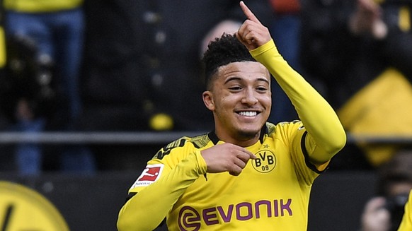 Dortmund&#039;s Jadon Sancho, left, celebrates after he scored the opening goal during the German Bundesliga soccer match between Borussia Dortmund and SC Freiburg in Dortmund, Germany, Saturday, Feb. ...