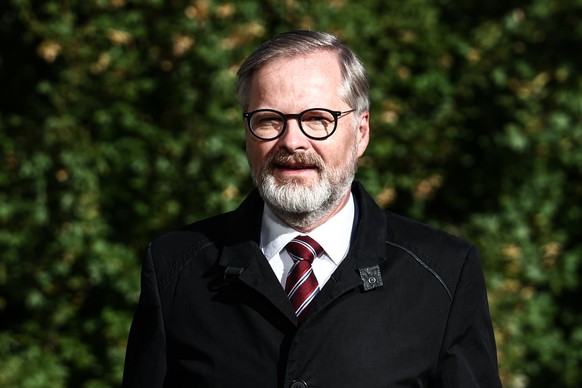 epa12428088 Czech Prime Minister Petr Fiala, chairman of the ODS party, and election leader of the Spolu (Together) coalition, arrives to casts his ballot during the parliamentary elections in Brno, C ...