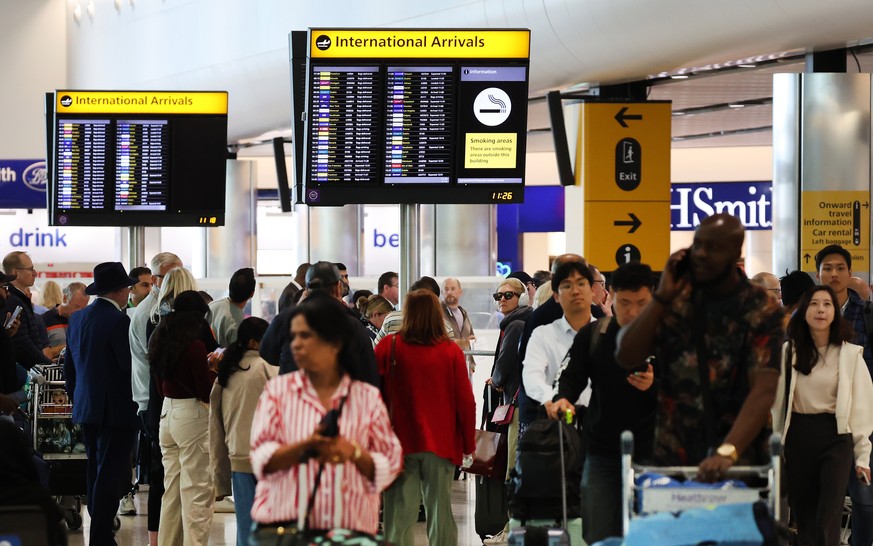 epa10828522 A crowd of people gather at Heathrow Airport in London, Britain, 30 August 2023. Travelers have been cautioned that flight disturbances might endure for several days. This follows a techni ...