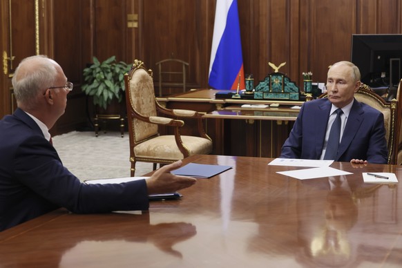 Russian President Vladimir Putin, right, speaks with the CEO of the Russian Direct Investment Fund Kirill Dmitriev during their meeting at the Kremlin in Moscow, Russia, Monday, Jan. 13, 2025. (Alexan ...