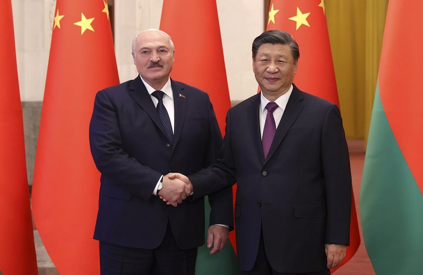 epa10497137 A handout photo made available by the Belarusian President Press service shows Belarusian President Aleksandr Lukashenko (L) and Chinese President Xi Jinping (R) pose for a handshake durin ...