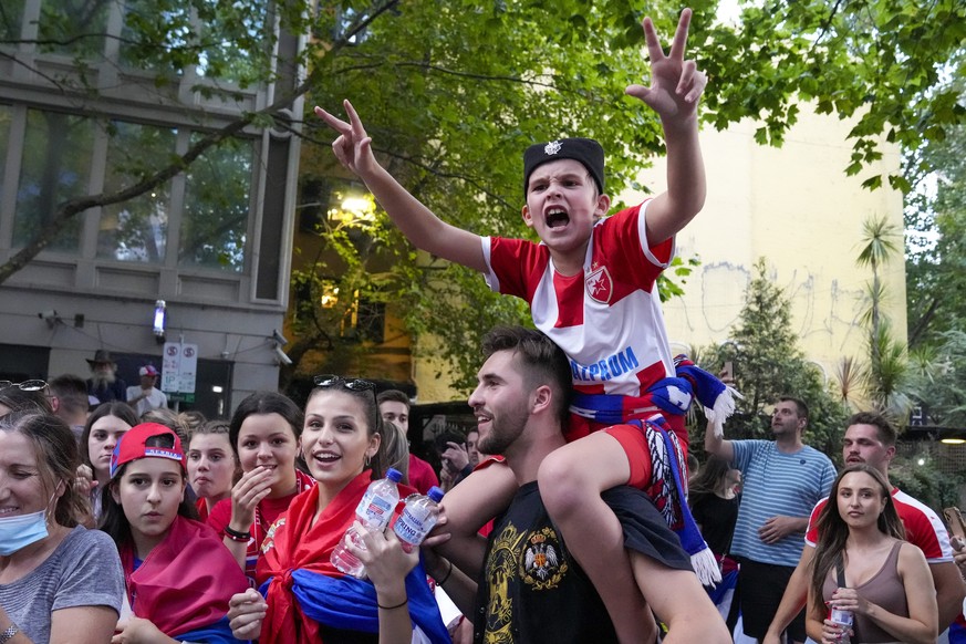 Fans cheer outside an immigration detention hotel where Serbian tennis star Novak Djokovic is confined in Melbourne, Australia, Monday, Jan. 10, 2022. An Australian judge who will decide whether top-r ...