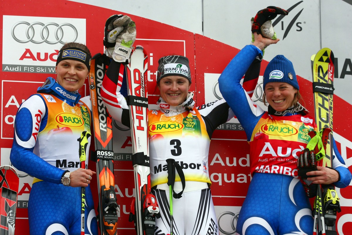 Elisabeth Goergl, of Austria, center, winner of an alpine ski, women's World Cup giant slalom, celebrates on the podium with second placed Manuela Moelgg, of Italy, left, and third placed Denise  ...