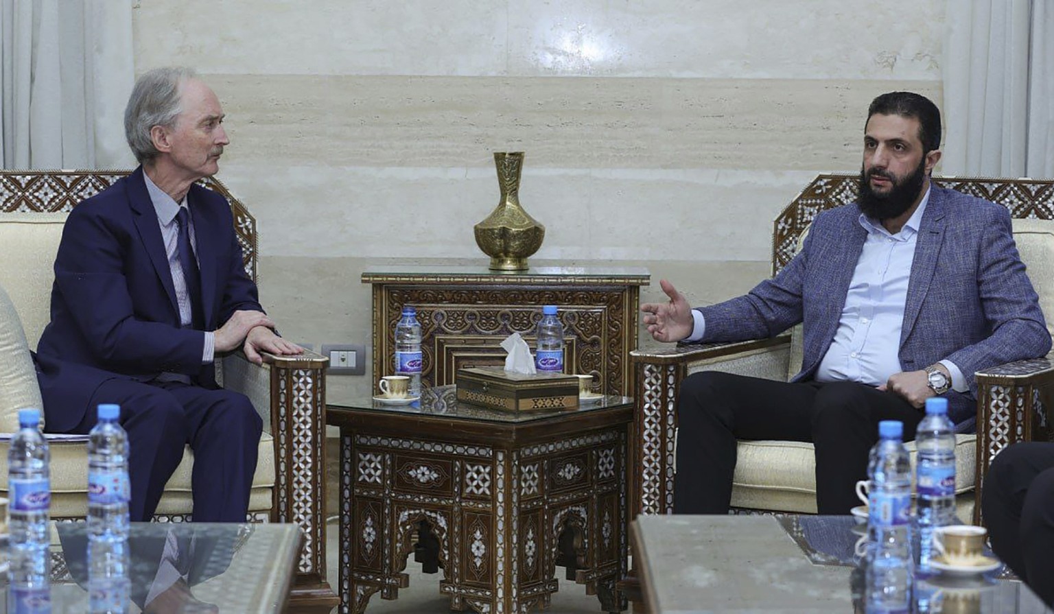 This photo, released by the Syrian official news agency SANA, shows the leader of Hayat Tahrir al-Sham Ahmad al-Sharaa, (Abu Mohammed al-Golani), right, as he meets with United Nations&#039; special e ...