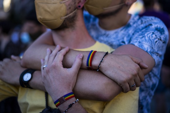 Two men attend a protest against the killing of Samuel Luiz in the Puerta del Sol in central Madrid, Spain, Monday, July 5, 2021. Authorities in northwestern Spain are asking for time to fully investi ...