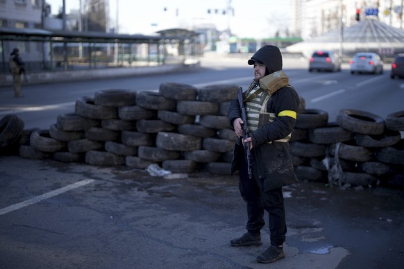 Civil defense personnel man a checkpoint in Kyiv, Ukraine, Saturday, Feb. 26, 2022. (AP Photo/Emilio Morenatti)