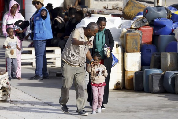 Newly arrived migrants receive assistance at the port of the Sicilian island of Lampedusa, southern Italy, on Monday, September 18, 2023.  The Italian cabinet met on Monday to take new measures to...