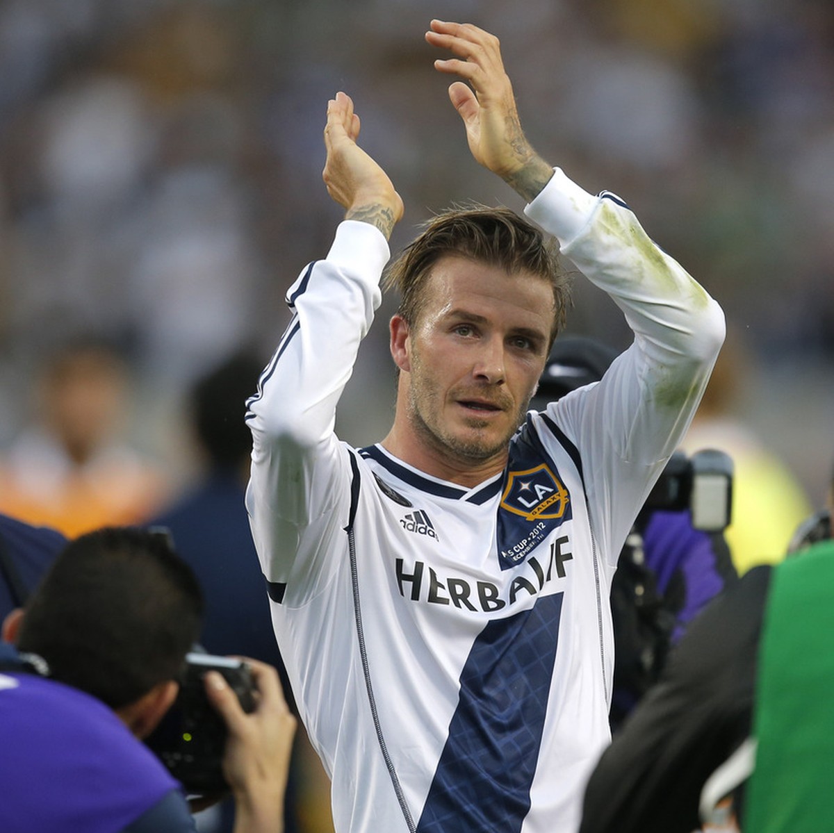 Los Angeles Galaxy's David Beckham, of England, acknowledges the fans as he leaves the field after the team's 3-1 win in the MLS Cup championship soccer match against the Houston Dynamo in C ...