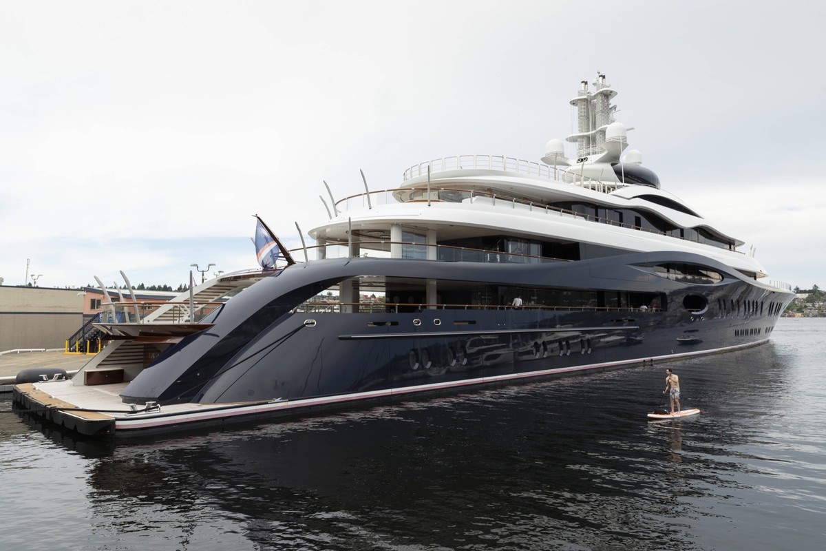 May 28, 2026, Seattle, Washington, USA: A man on a stand up paddleboard approaches Mark Zuckerbergs superyacht Launchpad.