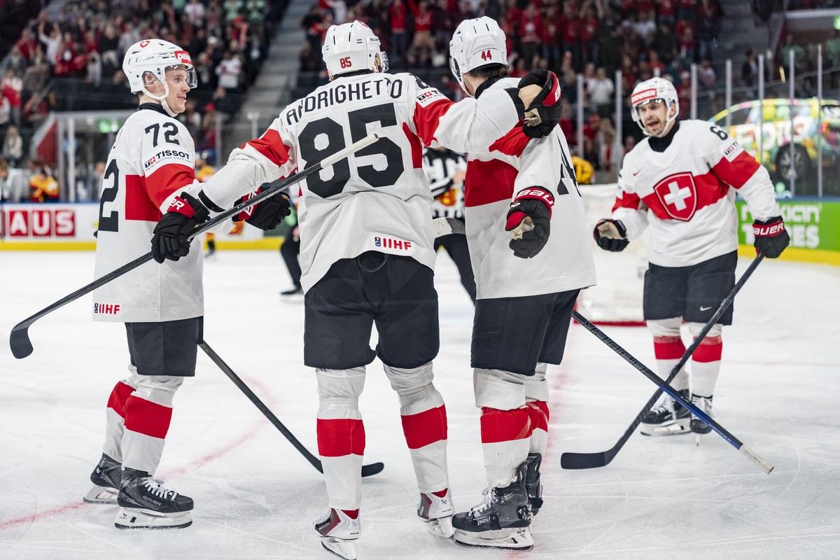 Switzerland's Sven Andrighetto, 2nd left, celebrates after his goal to 0:6 with Dominik Egli, left, and from right, Denis Malgin and Pius Suter, during the 2026 IIHF Men's Ice Hockey World C ...