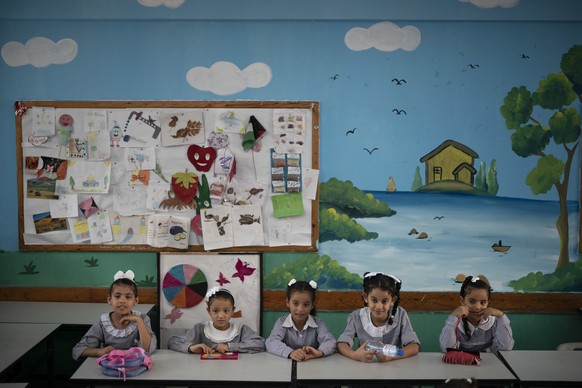 Girls sit inside a classroom at an UNRWA school during the first day of a new school year in Gaza City, Wednesday, Aug. 29, 2018. (AP Photo/Felipe Dana)