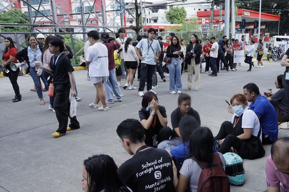 epa13023641 People gather at open spaces outside a commercial complex after an earthquake in Davao City, southern Philippines, 08 June 2026. According to the Philippine Institute of Volcanology and Se ...