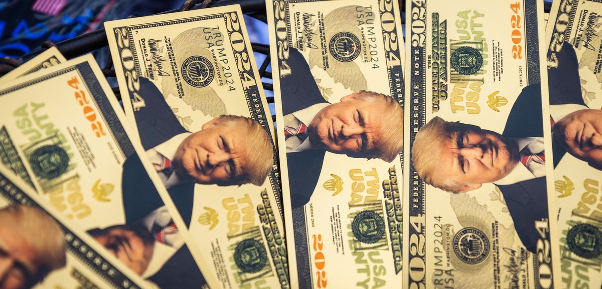 epa11573720 Fake money with a photo of former US president and current Republican presidential nominee Donald Trump outside a Trump campaign rally in Johnstown, Pennsylvania, USA, 30 August 2024. Trum ...