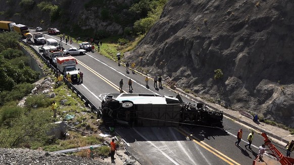 epa10814507 A passenger bus after an accident in the municipality of Tepelmeme, Oaxaca state, Mexico, 22 August 2023. Authorities in Oaxaca, a state in southern Mexico, confirmed that there are migran ...