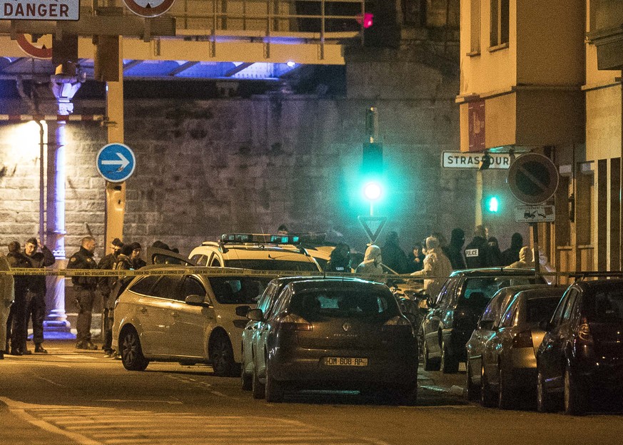 Investigating police officers work in a street of Strasbourg, eastern France, Thursday Dec. 13, 2018. A top French official says a man has been killed in a shootout with police in Strasbourg, but he h ...