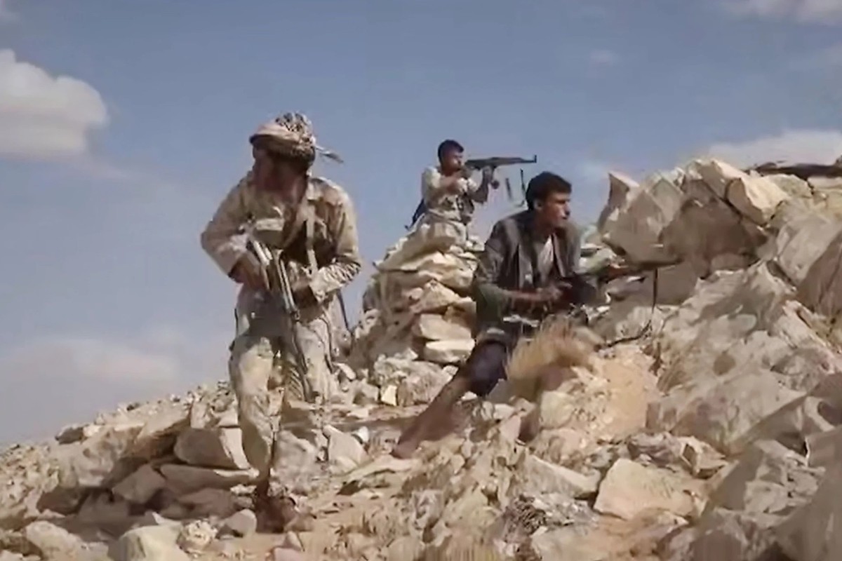 Des miliciens houthis se mettent à couvert dans les montagnes du Yémen.