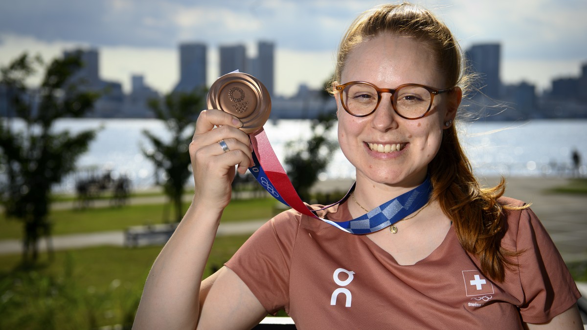 Nina Christen of Switzerland poses with her bronze medal before a virtual press conference after the women's shooting 10m air rifle finals at the 2020 Tokyo Summer Olympics in Tokyo, Japan, on Sa ...
