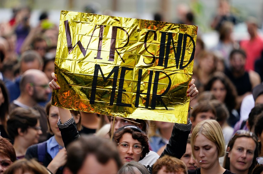 epa06987061 A demonstrator holds a golden foil with the text &#039;We are more&#039; during a vigil against racism nearby the federal state representation of Saxony in Berlin, Germany, 31 August 2018. ...