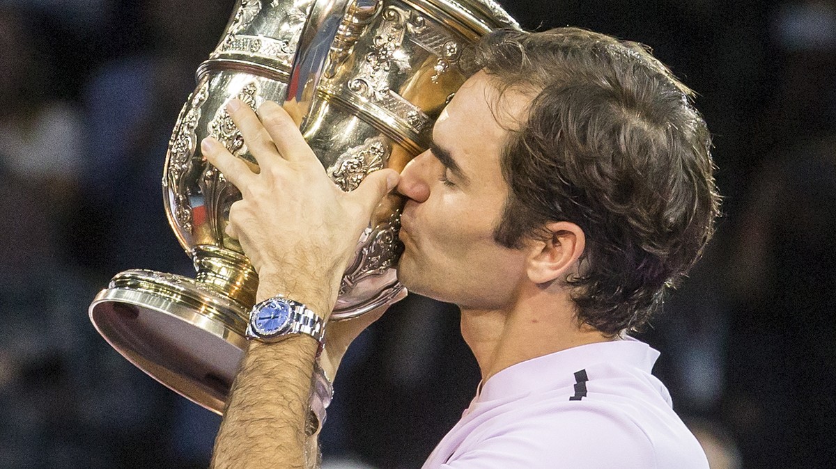 Switzerland's Roger Federer kisses the trophy during the award ceremony after the final between Switzerland's Roger Federer and Argentina's Juan Martin del Potro at the Swiss Indoors te ...