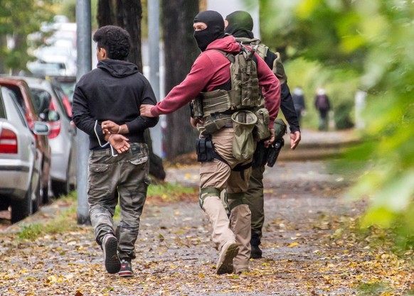 epa05576331 Police officers arrest a person in Chemnitz, Germany, 08 October 2016. A large-scale police operation is underway in Chemnitz in response to suspicions of plans for a bomb attack. Police a ...