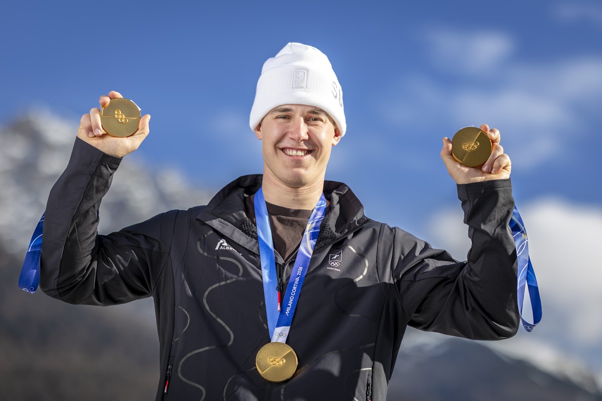 CAPTION CORRECTION: CORRECTS DATE - Gold medalist Switzerland's Franjo von Allmen poses for photographers with his three gold medals during a photocall outside the Swiss team hotel at the 2026 Ol ...