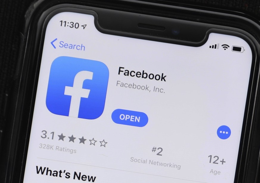 This Monday, July 30, 2019 photo shows an update information of Facebook application on a mobile phone displayed at a store in Chicago. The FBI is looking for outside contractors to monitor social med ...