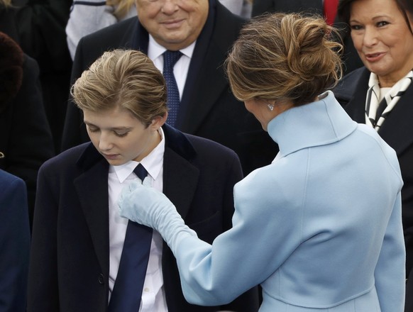 Incoming U.S. first lady Melania Trump adjusts son Barron&#039;s tie as they attend the presidential inauguration of President-elect Donald Trump at the U.S. Capitol in Washington, U.S., January 20, 2 ...