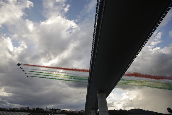 The Frecce Tricolore (Three-color Arrows) Italian Air Force aerobatic squad flies over the new San Giorgio Bridge on the occasion of its inauguration in Genoa, Italy, Monday, Aug. 3, 2020. Two years a ...