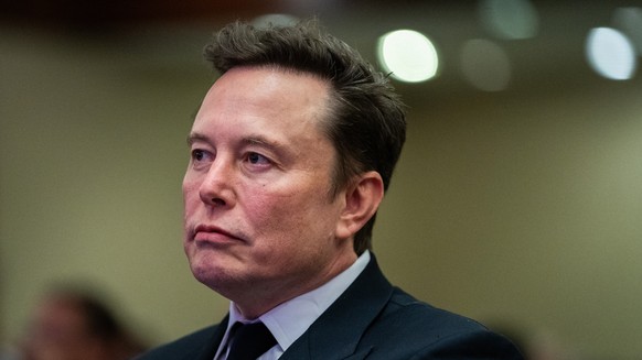 epa11718840 Elon Musk listens as US President-elect Donald Trump speaks during a meeting with House Republicans at the Hyatt Regency hotel in Washington, DC, USA, 13 November 2024. EPA/ALLISON ROBBERT ...