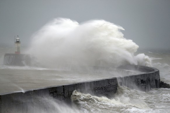 Waves crash into the wall at Newhaven south east England, as Storm Ciara, named by the Met Office national weather agency, hits the UK, Sunday Feb. 9, 2020. Trains, flights and ferries have been cancelled and weather warnings issued across the United Kingdom as a storm with hurricane-force winds up to 80 mph (129 kph) batters the region. (Andrew Matthews/PA via AP)