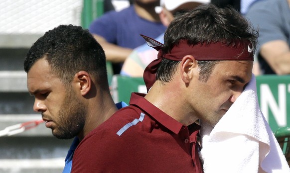 France's Jo-Wilfried Tsonga, left, crosses Swiss Roger Federer during their quarter final match of the Monte Carlo Tennis Masters tournament in Monaco, Friday, April 15, 2016. (AP Photo/Lionel Ci ...