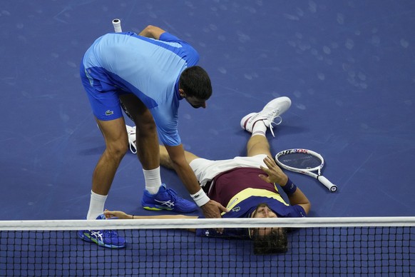 Novak Djokovic, of Serbia, offers Daniil Medvedev, of Russia, a hand up after a rally during the men&#039;s singles final of the U.S. Open tennis championships, Sunday, Sept. 10, 2023, in New York. (A ...