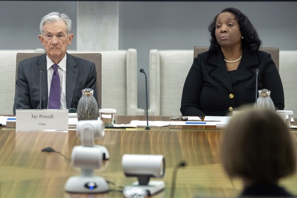 FILE - Federal Reserve Chairman Jerome Powell, and Board of Governors member Lisa Cook, right, listen during an open meeting of the Board of Governors at the Federal Reserve, June 25, 2025, in Washing ...